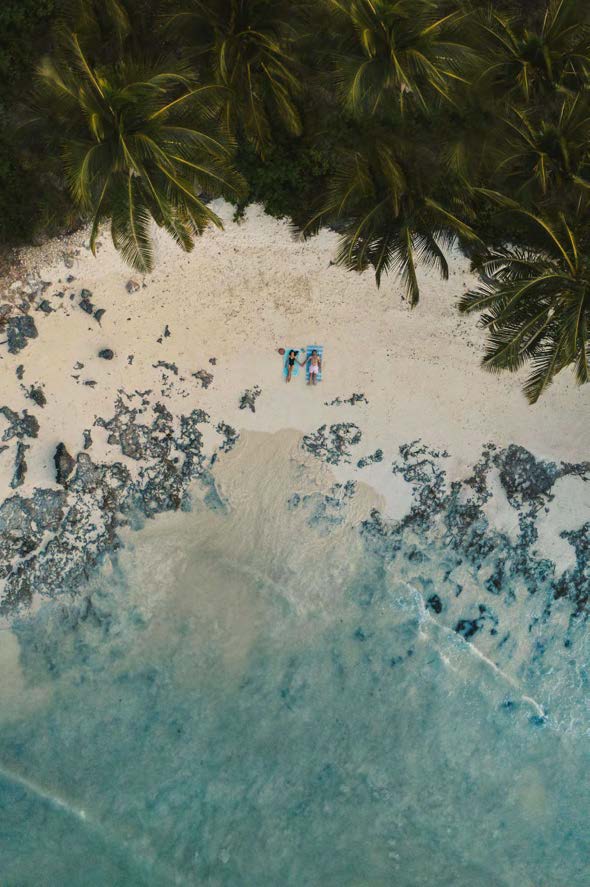 The sunlit beach and turquoise shallows of Paje